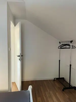 an empty room with a bed and a white wall at Hacienda DM in Visoko