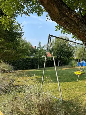 a swing set in a park with a tree at Hacienda DM in Visoko
