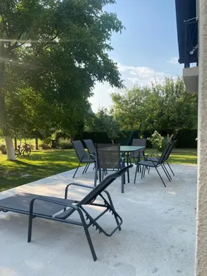 a group of chairs and a table in a park at Hacienda DM in Visoko