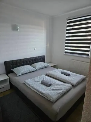 a bedroom with two beds and a window at Apartman D&A in Šišava