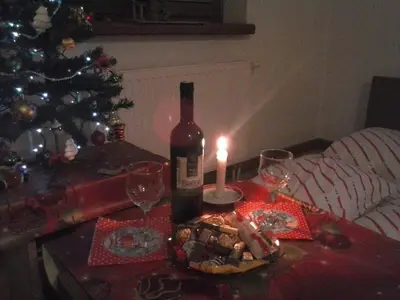 a bottle of wine and a candle on a table at Andrea & Goran 106 in Vlasic