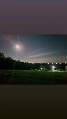 a view of a field at night with the moon at Kućica za odmor Srbac in Srbac