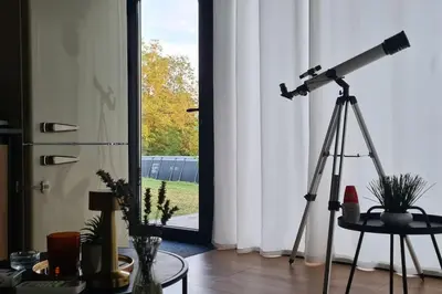 a camera on a tripod in a room with a window at Kućica za odmor Srbac in Srbac