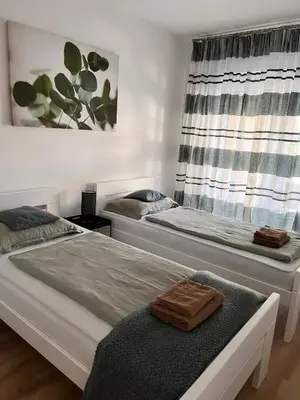 a bedroom with two beds and a window at Apartman Aldijana in Ripač