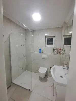 a bathroom with a shower and a toilet and a sink at Apartman Aldijana in Ripač