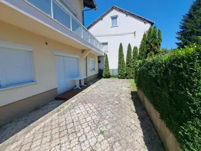 a house with a stone driveway in front of a house at Apartman Aldijana in Ripač
