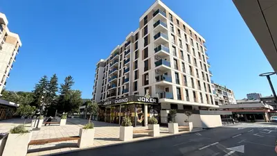 a large white building on a city street at Premium in Doboj