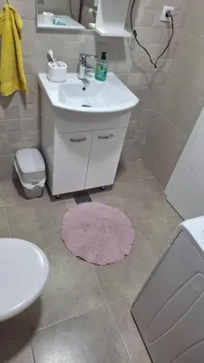 a bathroom with a sink and a toilet and a mirror at Premium in Doboj