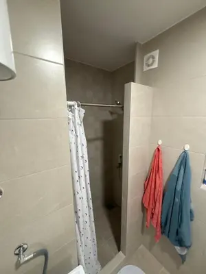 a bathroom with a shower curtain and a toilet at Premium in Doboj