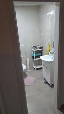 a bathroom with a sink and a toilet at Premium in Doboj