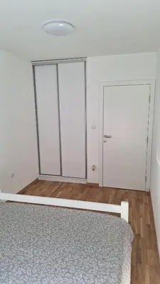 a white room with a bed and a closet at Premium in Doboj