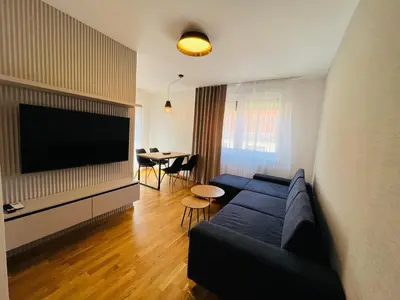 a living room with a couch and a flat screen tv at Apartman Tara Lux in Banja Luka