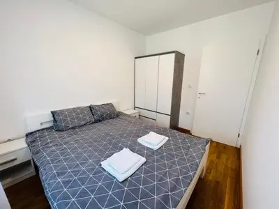 a bedroom with a bed with two towels on it at Apartman Tara Lux in Banja Luka