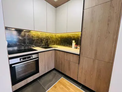 a kitchen with white cabinets and a stove at Apartman Tara Lux in Banja Luka