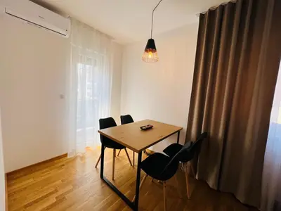 a dining room table and chairs in a room at Apartman Tara Lux in Banja Luka