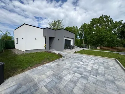 a white house with a patio in a yard at Villa Sofia in Bihać