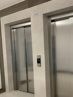 two elevator doors in a building with a sign on it at Apartman Boutique Banja Luka in Banja Luka