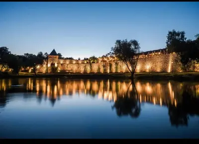 a castle with a lake in front of it at Apartman Boutique Banja Luka in Banja Luka