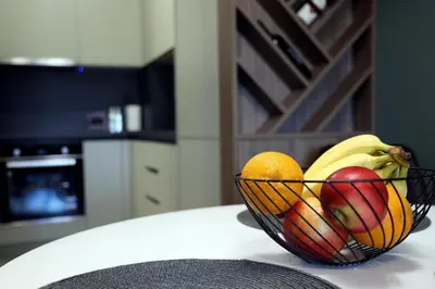 a bowl of fruit on a table in a kitchen at Apartman Boutique Banja Luka in Banja Luka