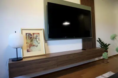 a living room with a large flat screen tv on the wall at Apartman Boutique Banja Luka in Banja Luka