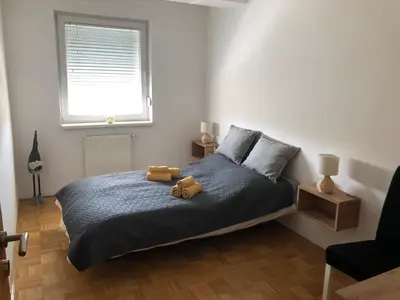 a bedroom with a bed with a teddy bear on it at City Apartment Lukavac in Lukavac
