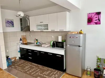 a kitchen with a stainless steel refrigerator and a sink at City Apartment Lukavac in Lukavac