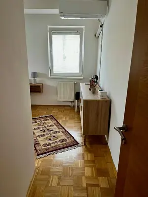a bathroom with a sink and a desk and a window at City Apartment Lukavac in Lukavac