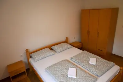 a bedroom with two twin beds and a cabinet at Apartman Pavić in Livno