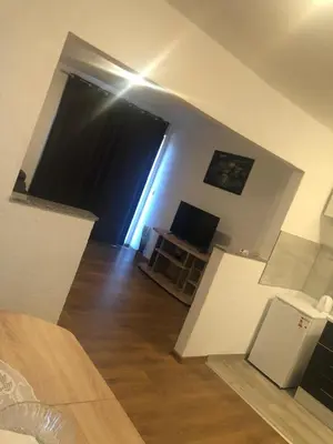 a living room with a large window and a television at Apartman Pavić in Livno