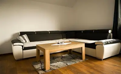 a living room with a black and white couch and a table at Apartman Pavić in Livno