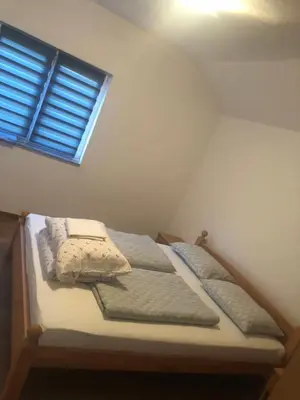 a bed in a room with a window at Apartman Pavić in Livno