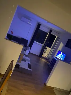 an empty living room with a table and a television at Apartman Pavić in Livno