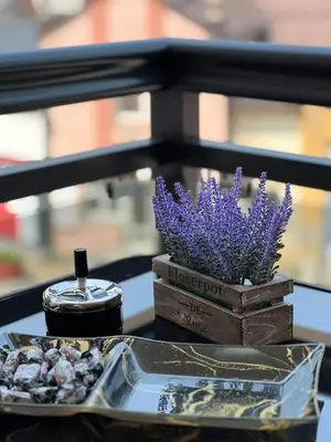 a table with a container of lavender and a candle at Apartman Dioniz Fojnica in Fojnica