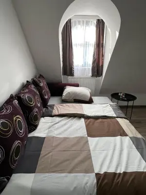 a bedroom with a large bed with a large window at Apartman Zen Fojnica in Fojnica