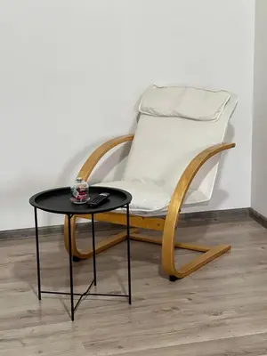 a chair and a table next to a coffee table at Apartman Zen Fojnica in Fojnica