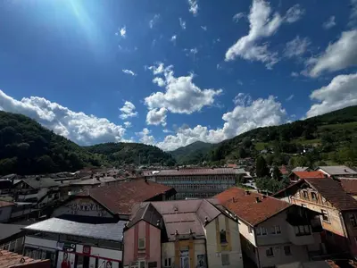 a view of a town with mountains in the background at Apartman Zen Fojnica in Fojnica
