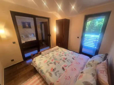a bedroom with a bed and a large window at Villa Djuric in Slatina Varoš
