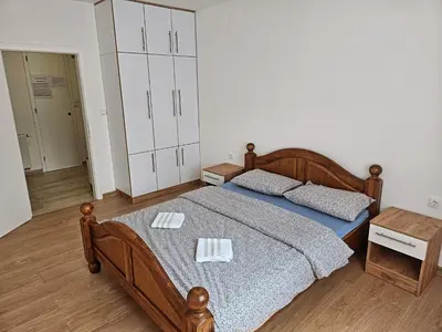 a bedroom with a bed with two towels on it at Stan TeslićTrg in Teslić