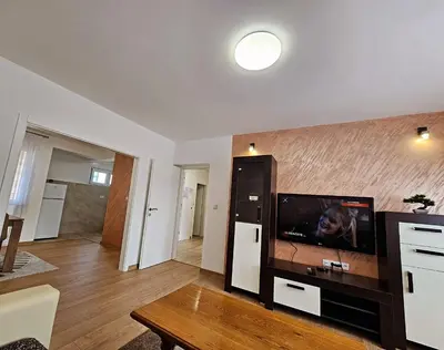 a living room with a flat screen tv on a wall at Stan TeslićTrg in Teslić