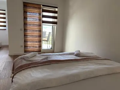 a large bed in a bedroom with a window at Luxury Pyramid Apartment Visoko in Visoko