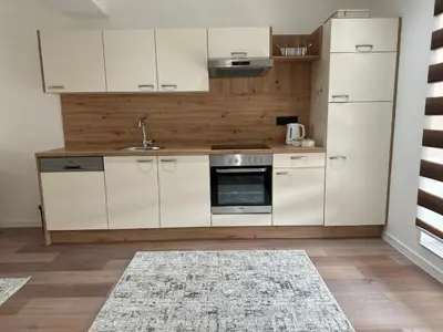 a kitchen with white cabinets and a sink at Luxury Pyramid Apartment Visoko in Visoko
