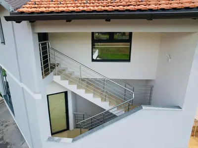 an external view of a building with stairs at Luxury Pyramid Apartment Visoko in Visoko