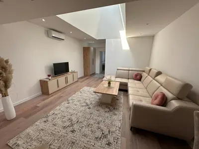 a living room with a couch and a table at Luxury Pyramid Apartment Visoko in Visoko