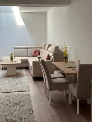 a living room with a couch and a table and chairs at Luxury Pyramid Apartment Visoko in Visoko