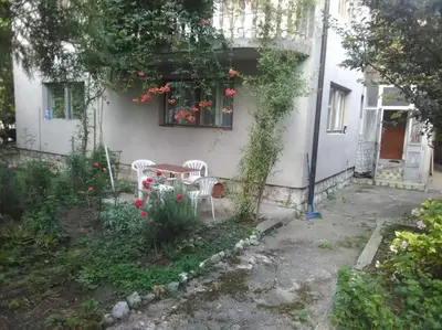 a table and chairs in front of a house at Apartman Turizam Plus in Travnik