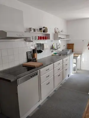 a kitchen with white cabinets and a counter top at Apartman Turizam Plus in Travnik