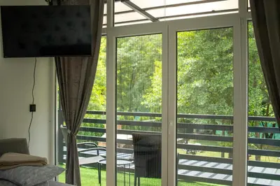 a sliding glass door with a view of a patio at Natura na Uni in Bihać