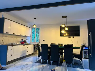 a kitchen with a table and chairs in a room at Natura na Uni in Bihać