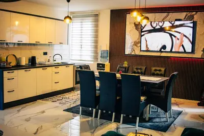 a kitchen with a dining room table and chairs at Natura na Uni in Bihać