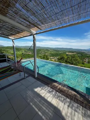 a swimming pool on the roof of a house at Green Sea Resort - Zeleno More in Visoko